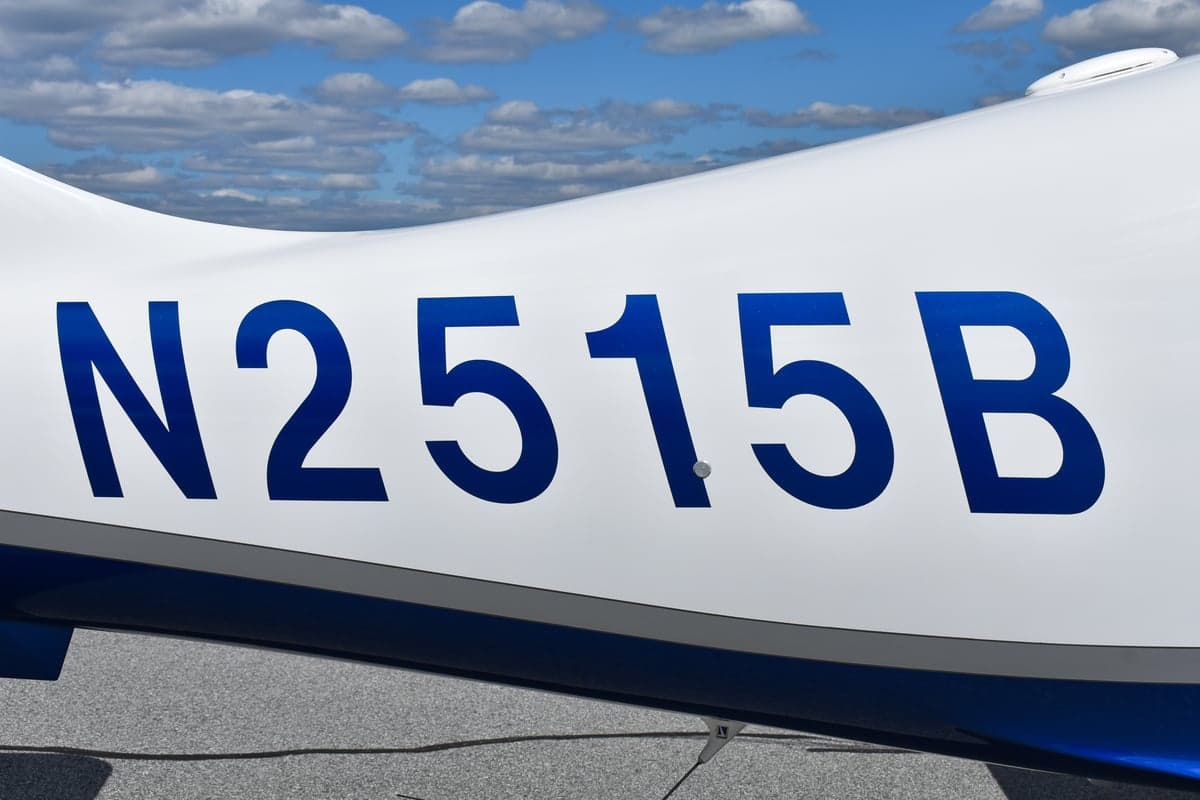 Columbia 400 aircraft N2515B on the ramp with doors open.