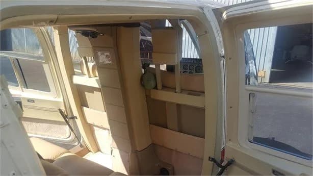 Interior view of the helicopter cabin with beige upholstery.