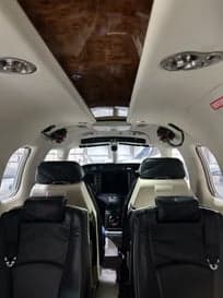 View of the cabin seats and cockpit from the rear of the aircraft.