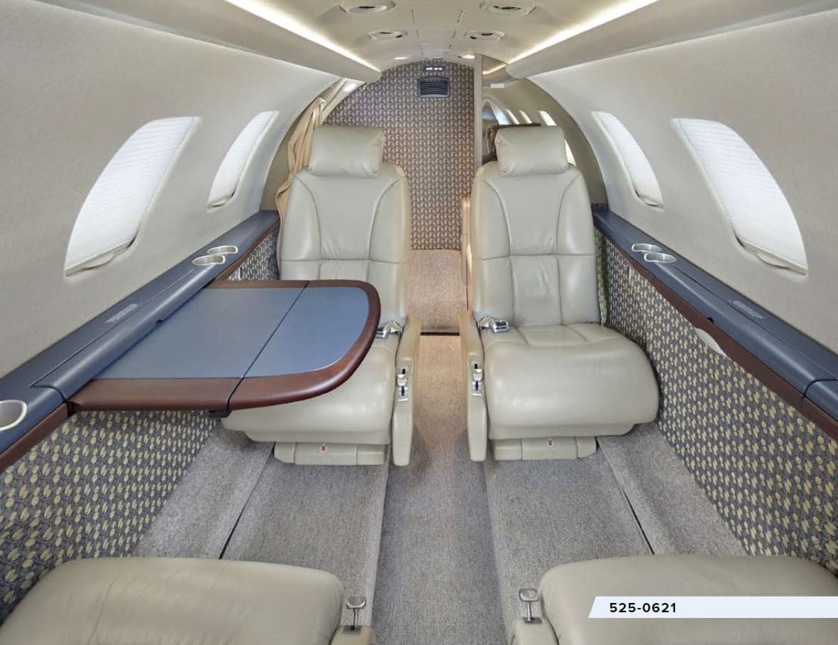 The interior of the aircraft features leather seats and a table.