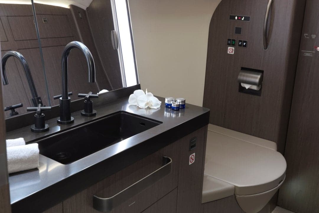 Interior of the aircraft featuring a bathroom with a sink and toilet.