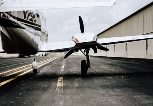 Rear view of the aircraft N12SB on the tarmac.