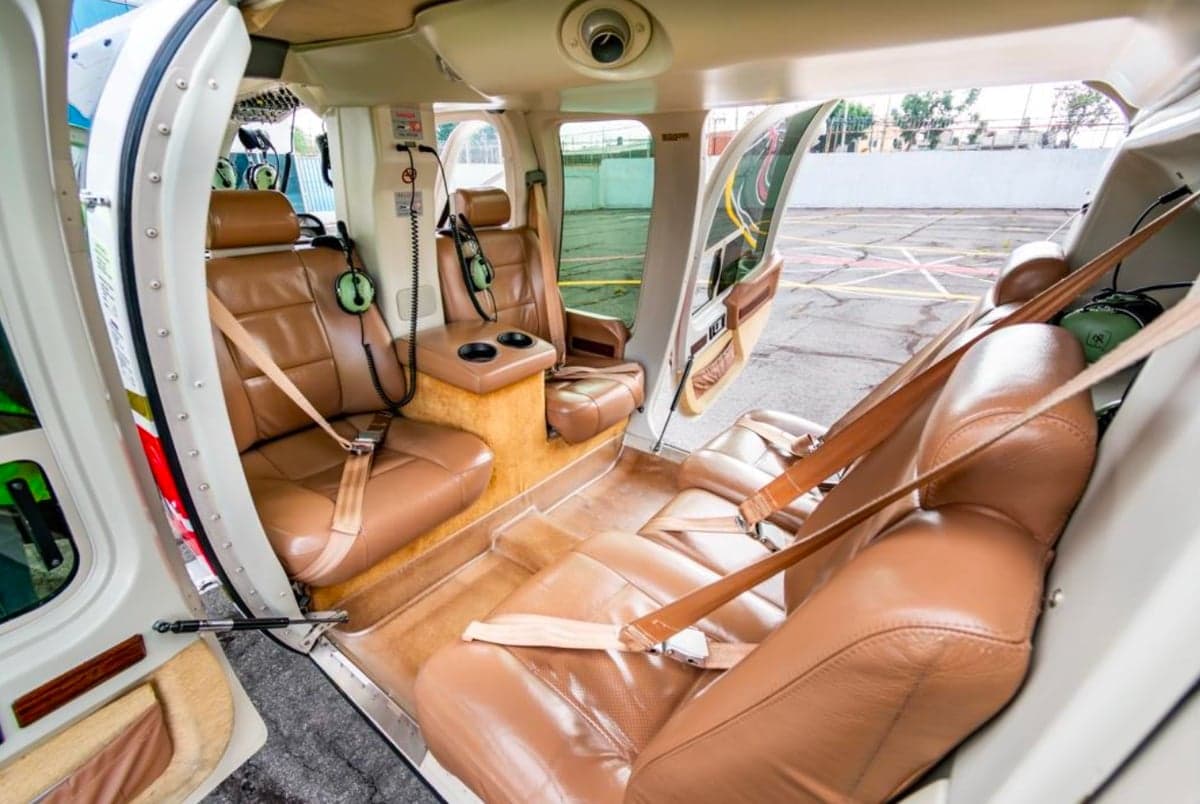 View of the brown leather seats in the cabin of the helicopter.