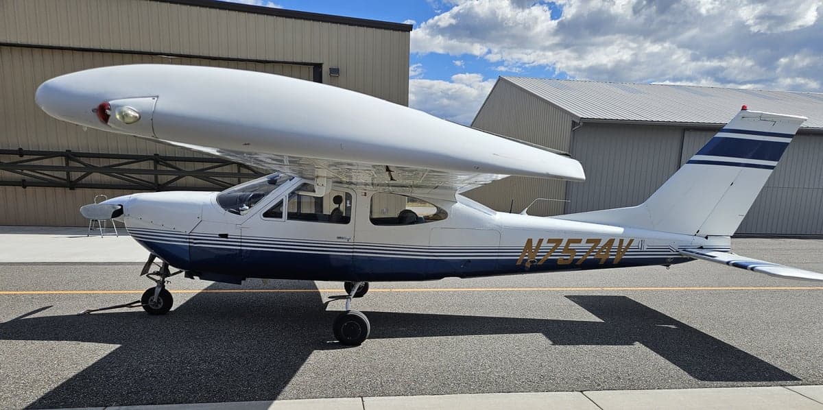 A Cessna 182 Skylane, tail number N7574V, parked on the tarmac.