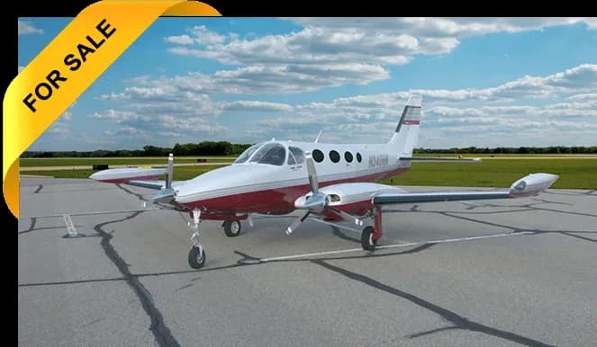 A red and white twin-engine aircraft with registration N340HR is parked on the tarmac with a 'FOR SALE' banner.