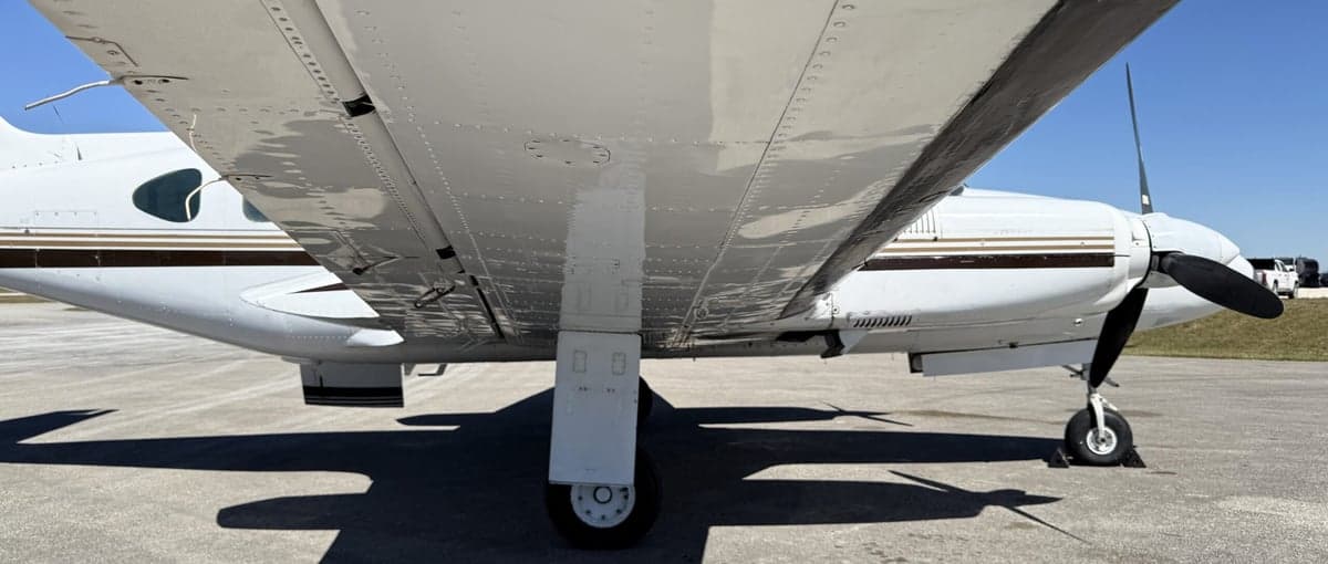 Close-up view of the wing and landing gear of the aircraft.