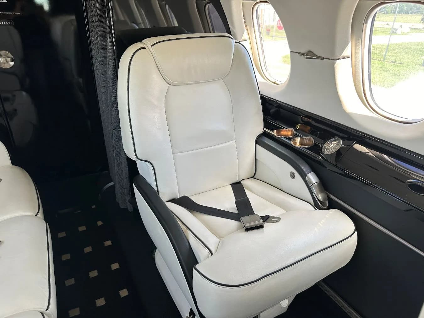 Close up of a white leather seat in the Hawker 400XP cabin.