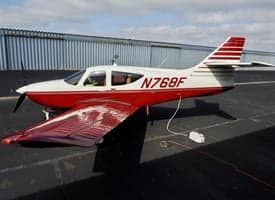 Side view of the N768F aircraft on the tarmac.