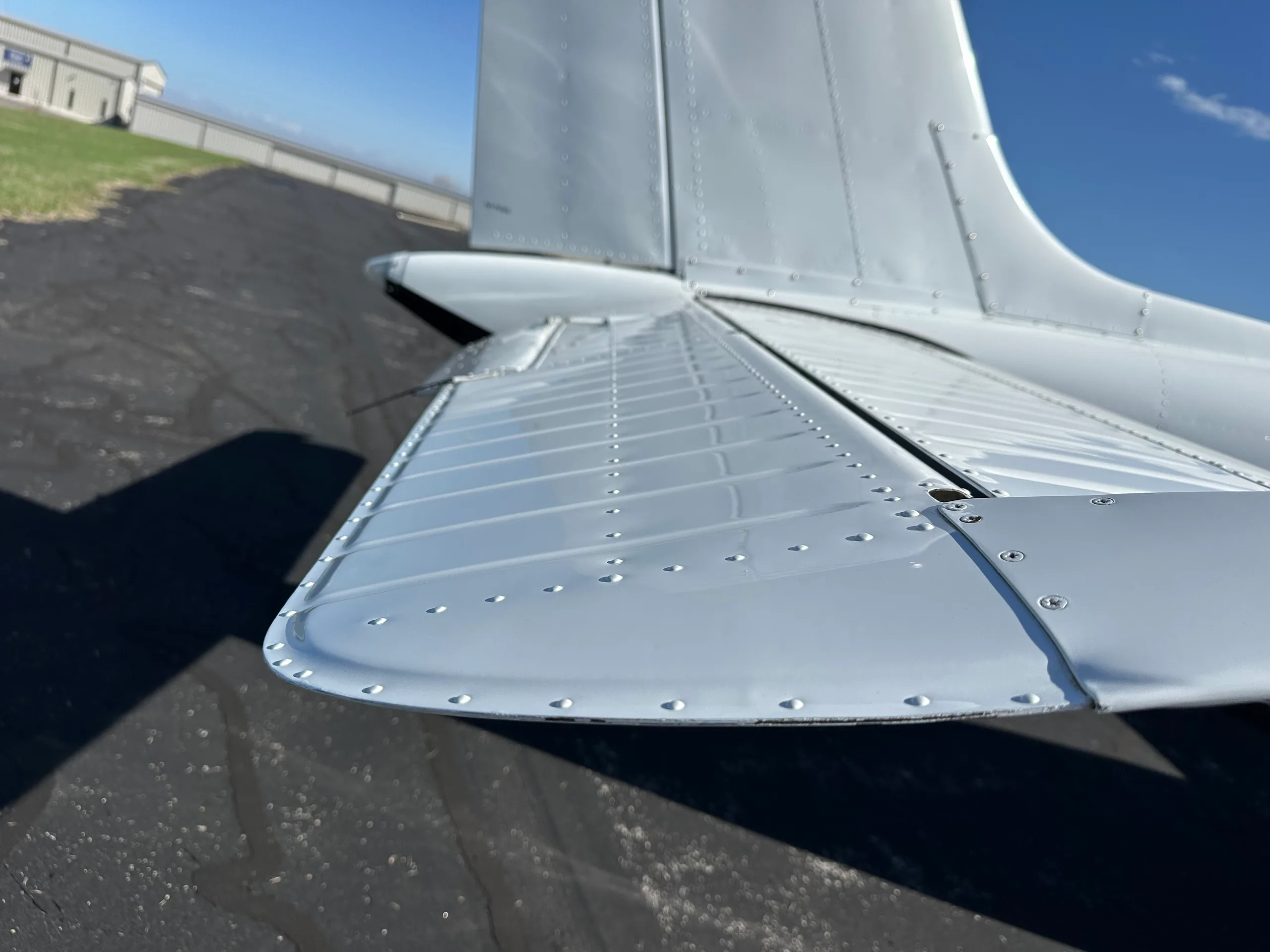 A close-up of the tail and wing of a Beechcraft Bonanza aircraft.