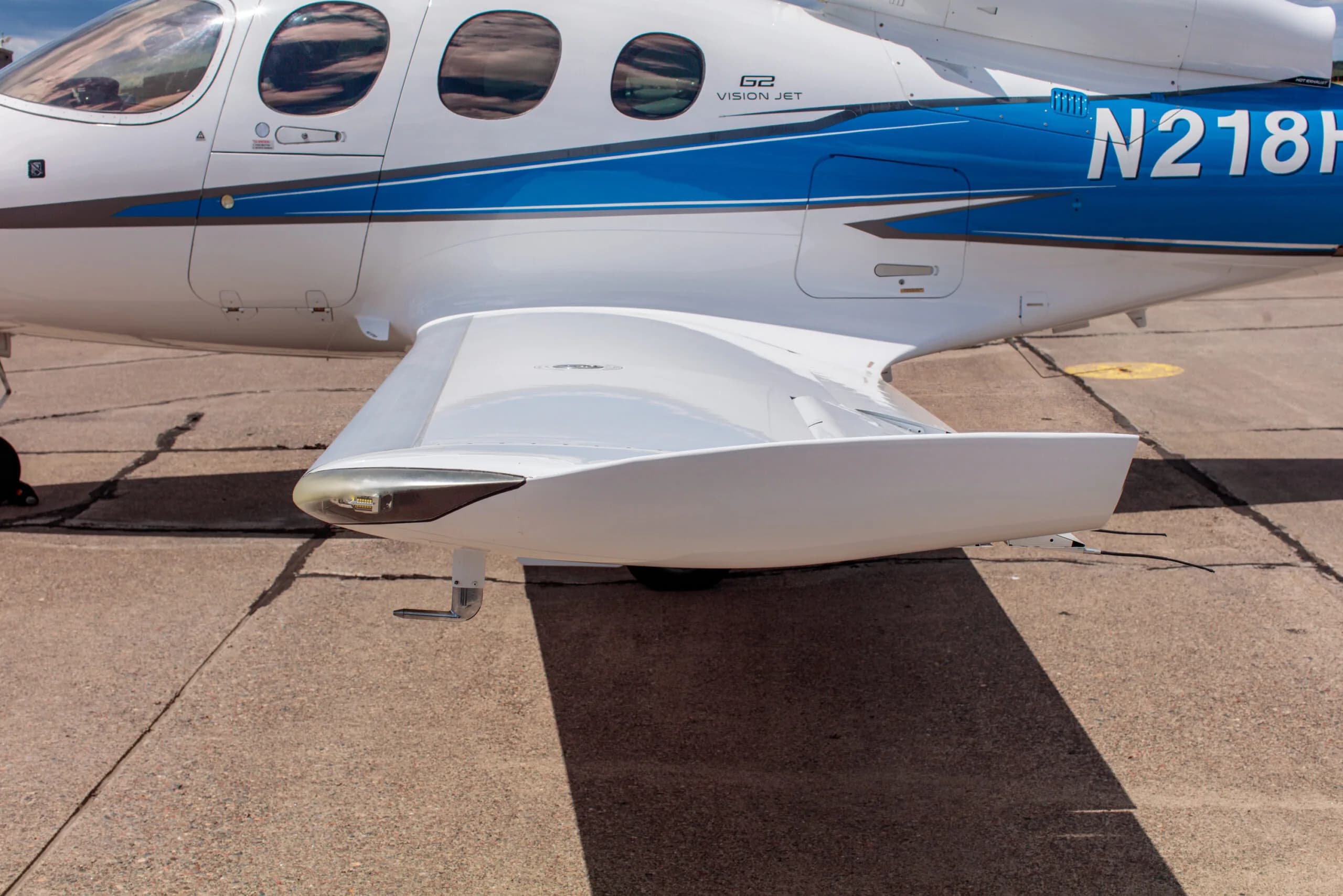 Close-up of the wing root and landing gear fairing of the Cirrus Vision Jet (N218HP).