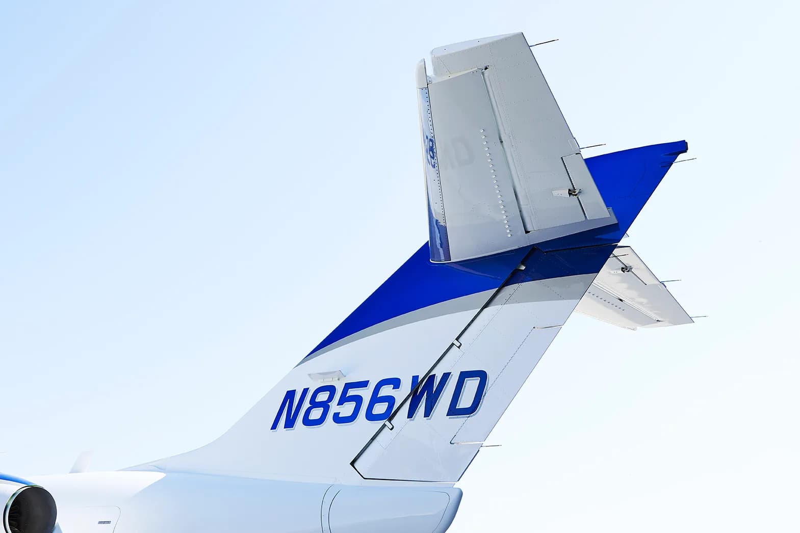 Close-up view of the tail of a blue and white HondaJet, showing the N856WD registration.