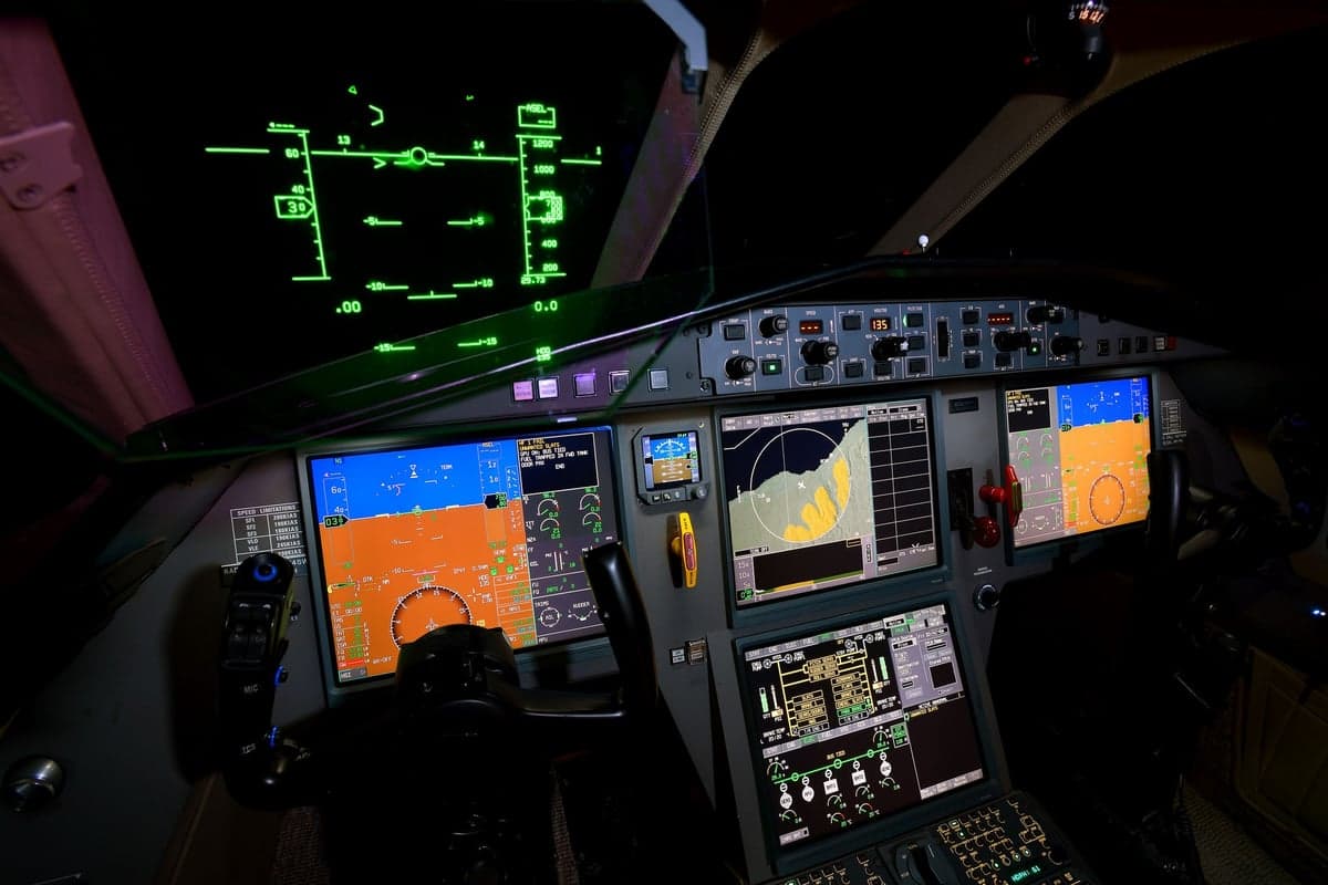 The cockpit of a Falcon aircraft with illuminated displays.