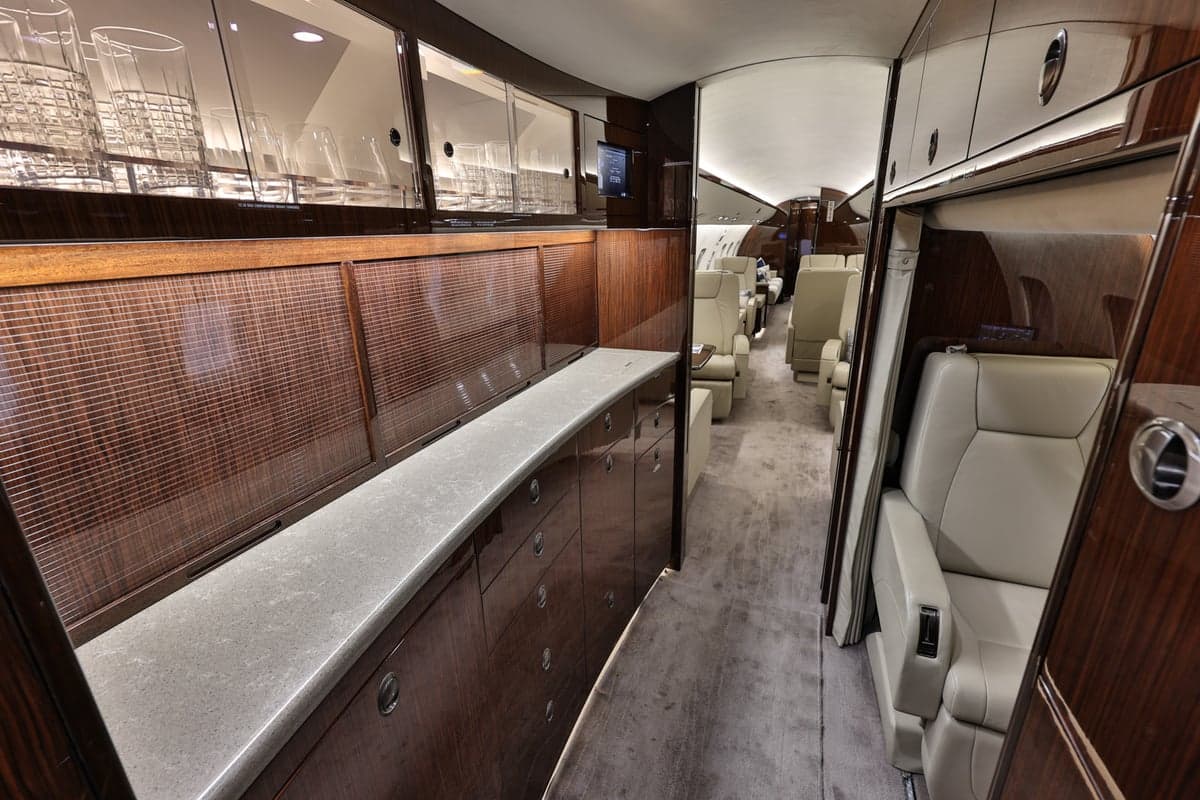 View of the Bombardier Global Express cabin interior with wood accents and seating.