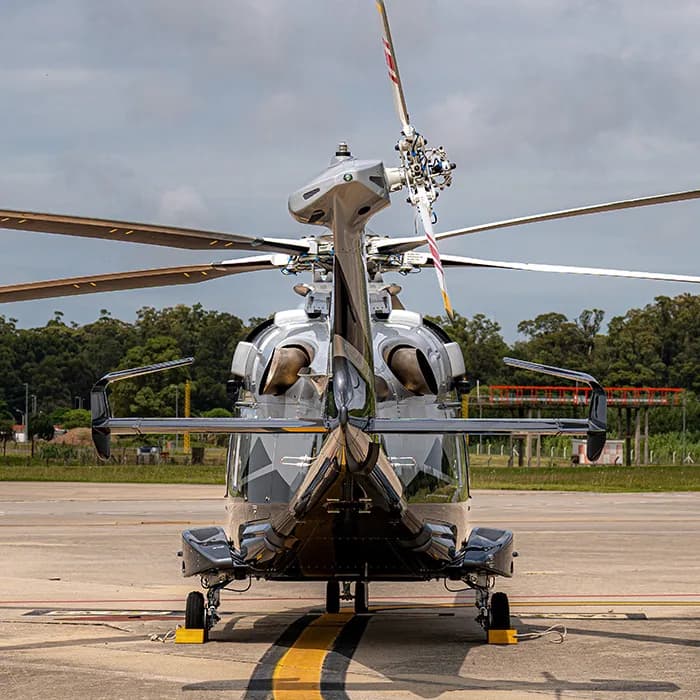 Rear view of the helicopter with its tail rotor and engines visible.