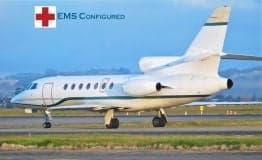 A white aircraft with EMS configuration is on the runway.