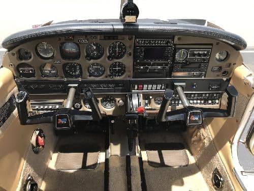 The aircraft's instrument panel and controls in the cockpit.