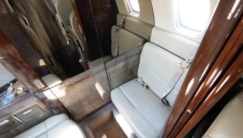 View of the side seating and mirror in the Cessna Citation CJ3 cabin.