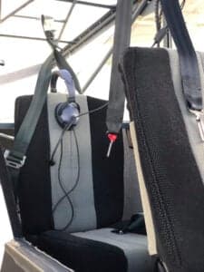 Close-up of the aircraft's seat with a headset hanging on it.
