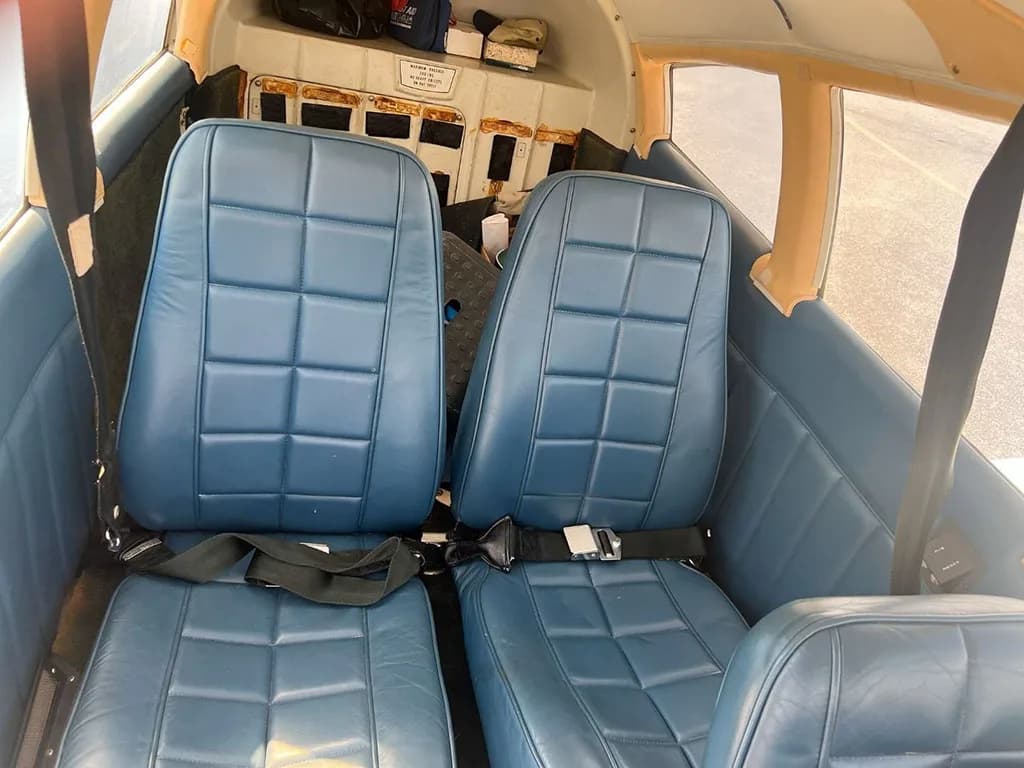 The blue quilted passenger seats in the cabin interior of the aircraft.