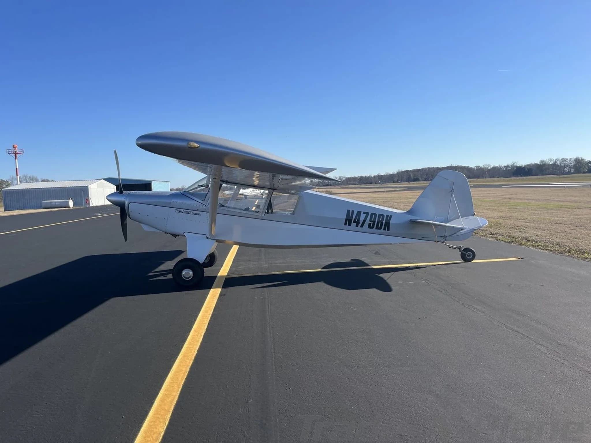 Three-quarter front view of a silver Bearhawk Patrol aircraft with registration N479BK on an asphalt tarmac.