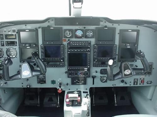 The cockpit of the aircraft with a gray instrument panel.