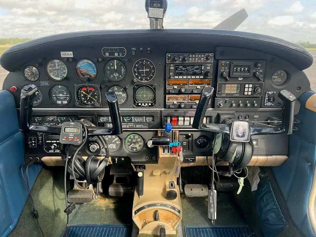The instrument panel and dual yokes of the aircraft cockpit, featuring various gauges and avionics.