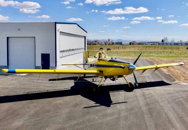 A yellow and blue Air Tractor AT-400 aircraft is parked on the tarmac.