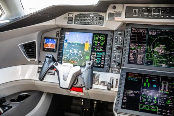 Close-up view of the aircraft cockpit controls and display screens.