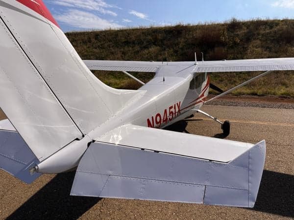 Rear view of the Cessna 210 aircraft N9451X showing the tail and empennage.