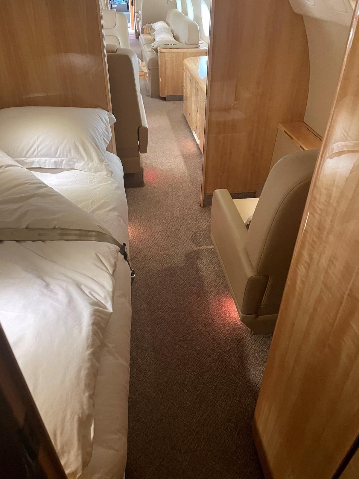 A view of the interior of the aircraft, showing a bed and seating area.