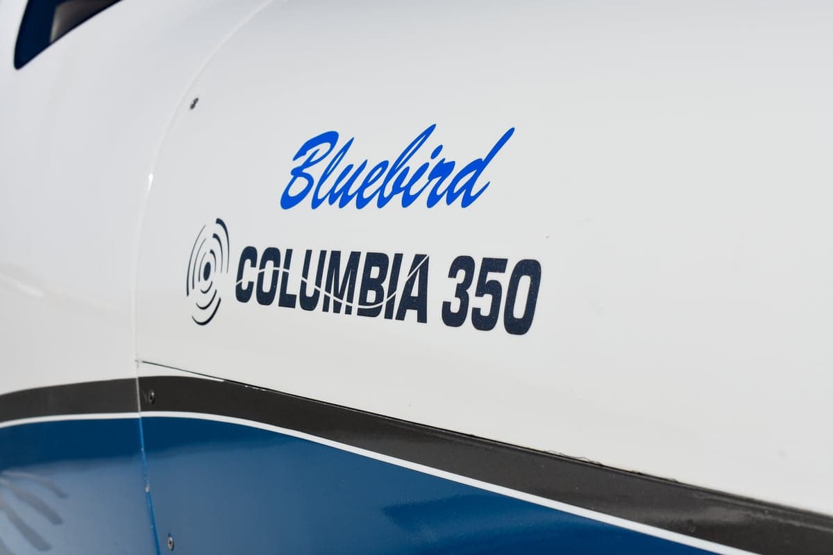 Front quarter view of a Bluebird Columbia 350 aircraft with open doors.