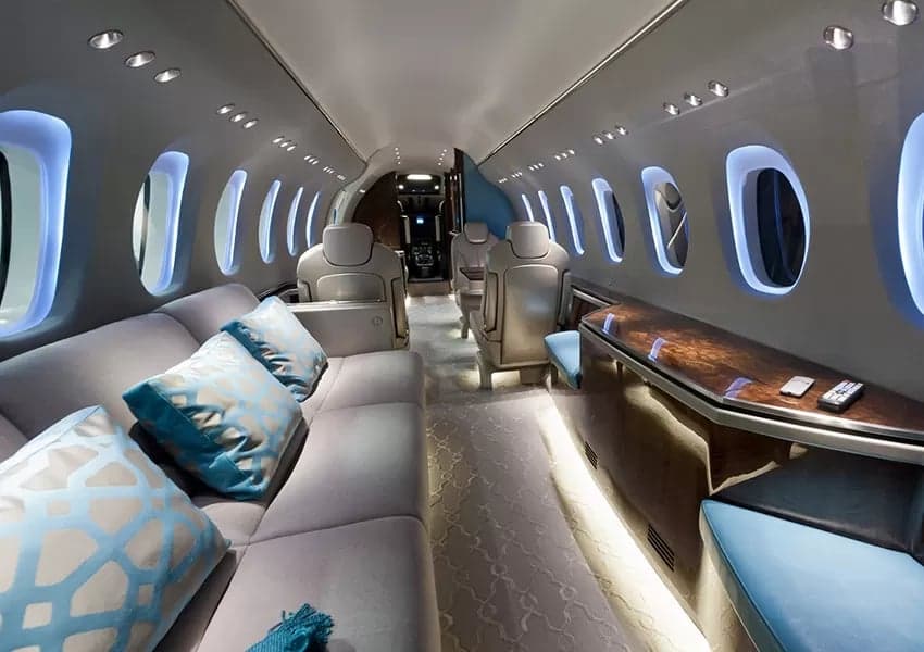 The luxurious interior of a private jet features comfortable seating and elegant design.