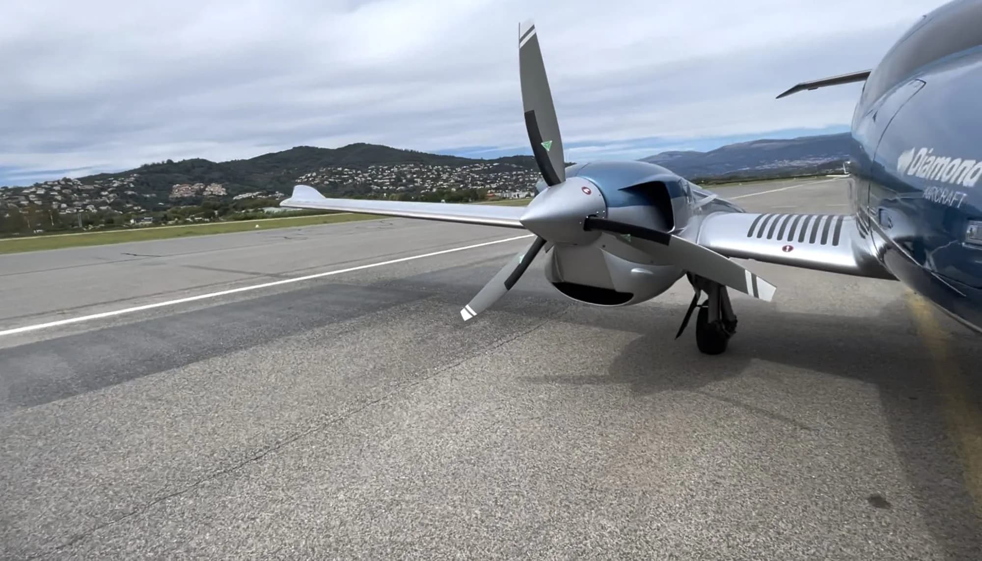 Close-up of the propeller and nose of a Diamond DA62 aircraft.