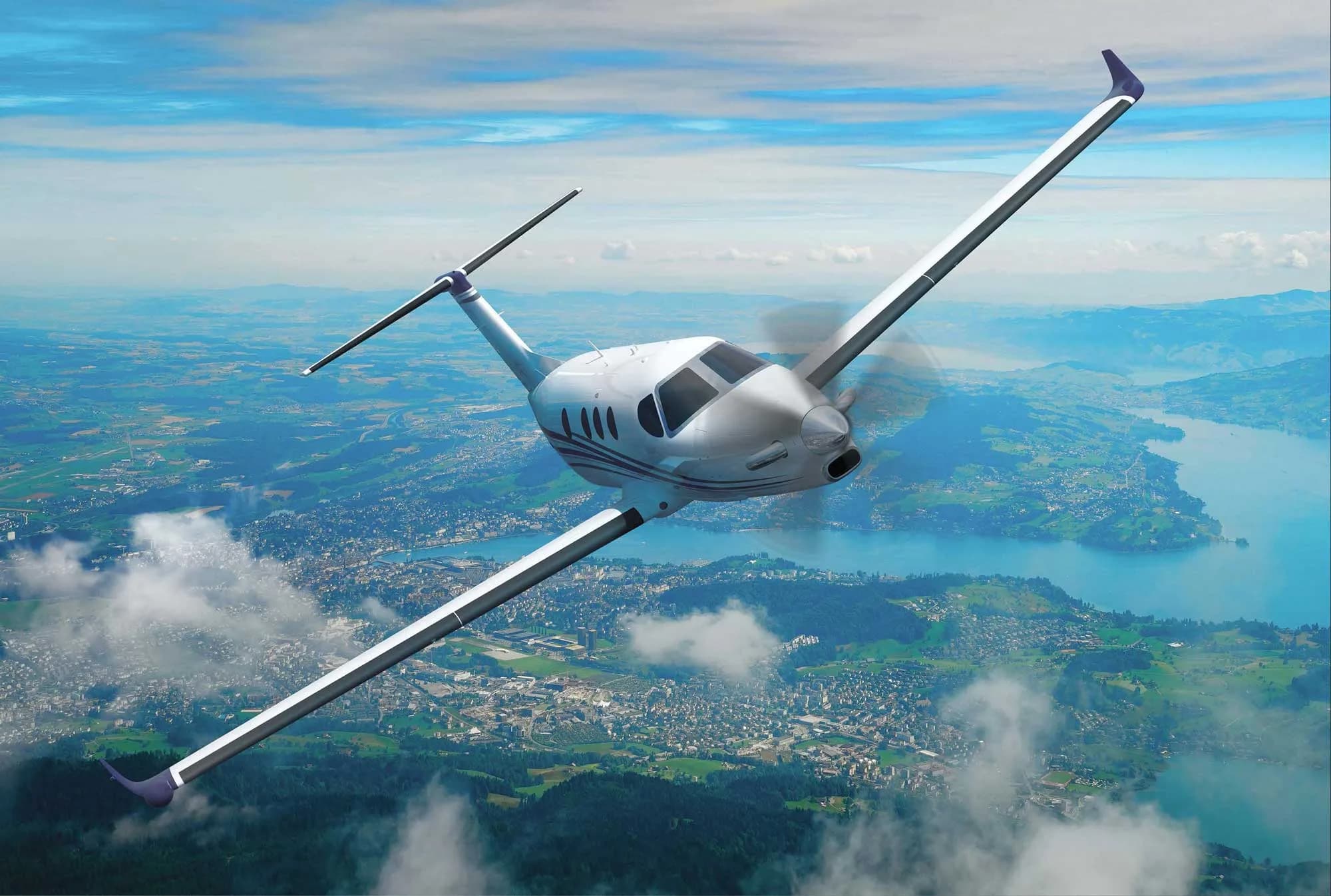 Pilatus PC-12 NGX flying over a city.