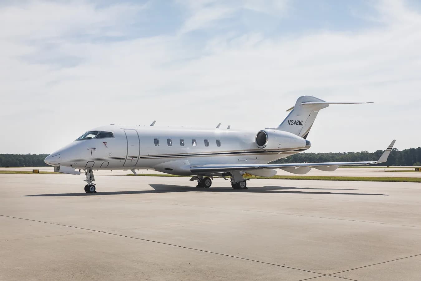 Side view of the Challenger 300 aircraft with registration N248ML on the tarmac.