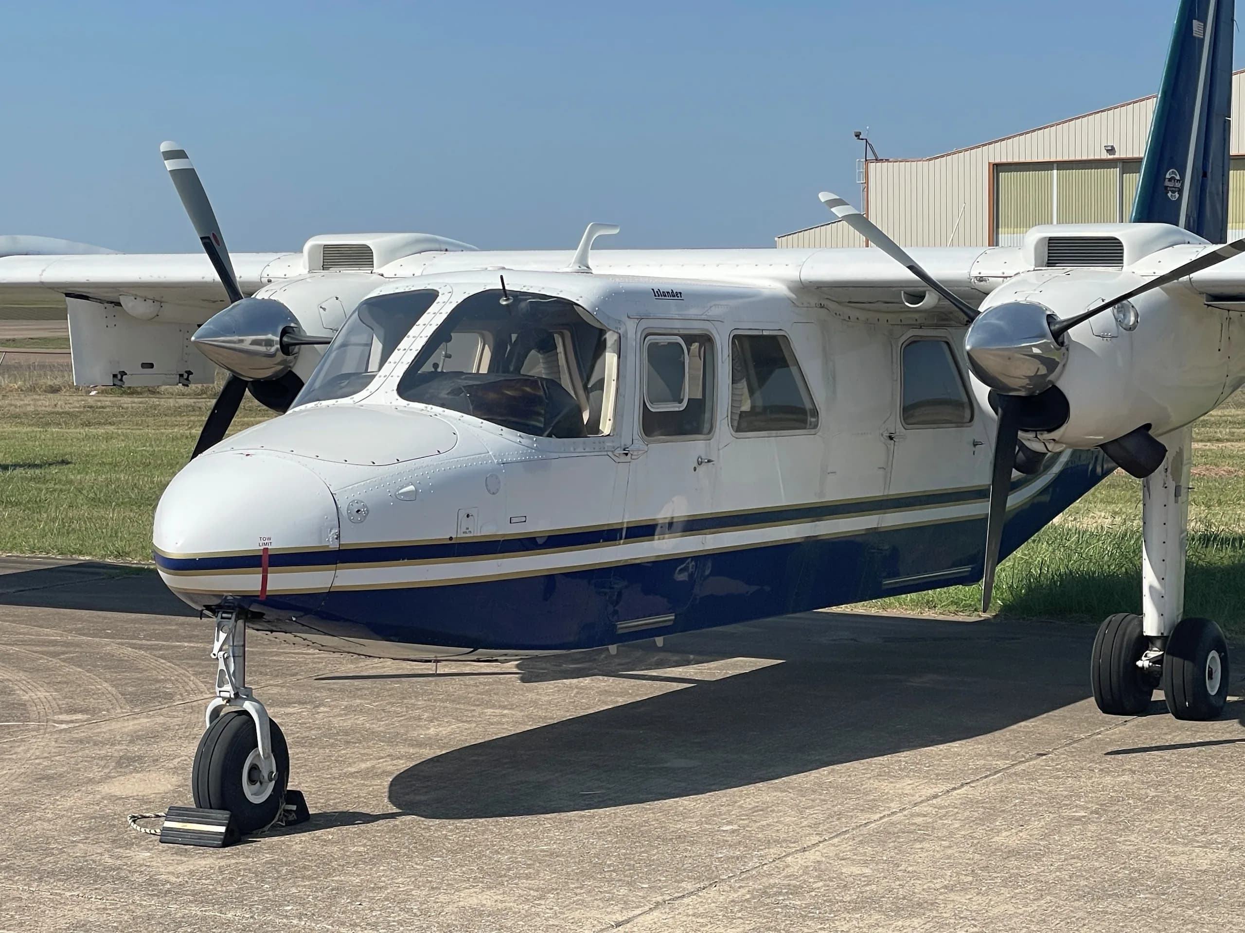 Close up of the front of the white and blue aircraft.