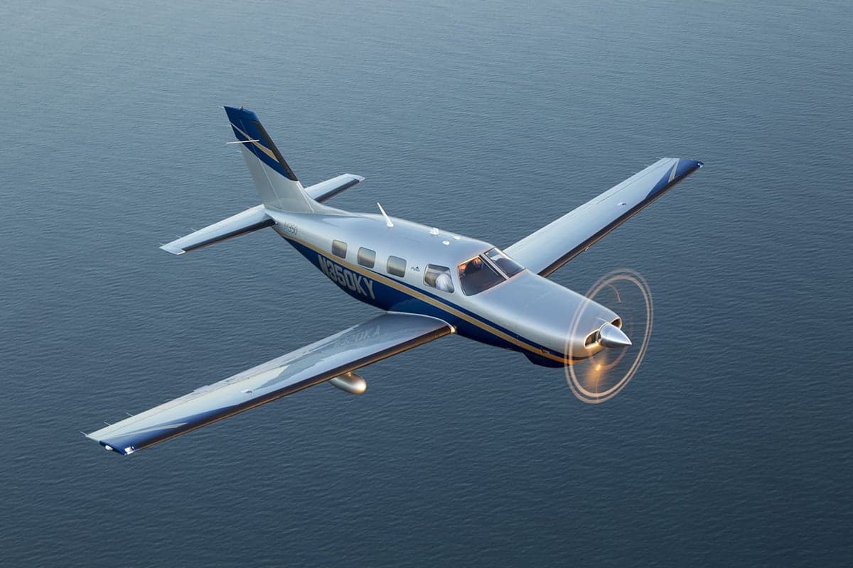 Aerial view of a Piper M350 over water.