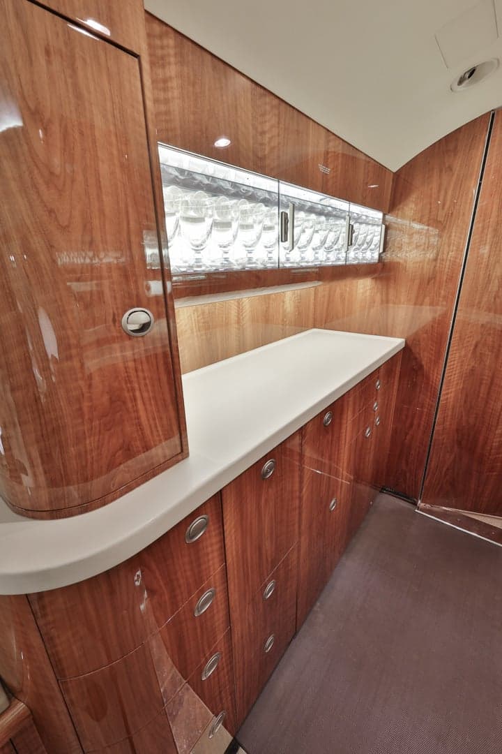 Interior view of the aircraft galley with wood cabinetry and countertop.