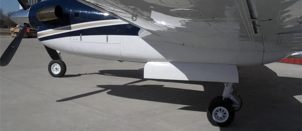 A King Air aircraft landing gear and lower fuselage are shown.