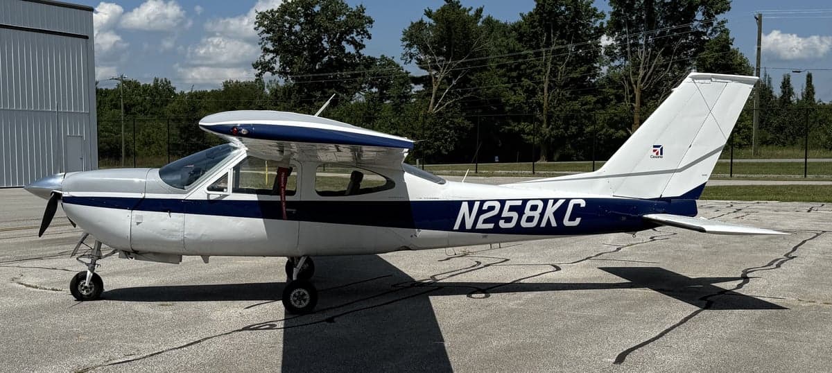 Side profile of the N258KC Cessna aircraft with a white and blue paint scheme.