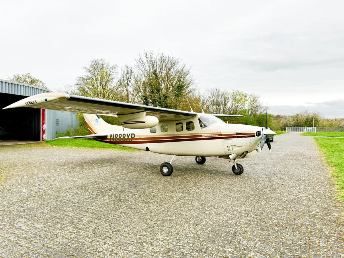 Cessna Centurion with a white and brown paint scheme on the tarmac.