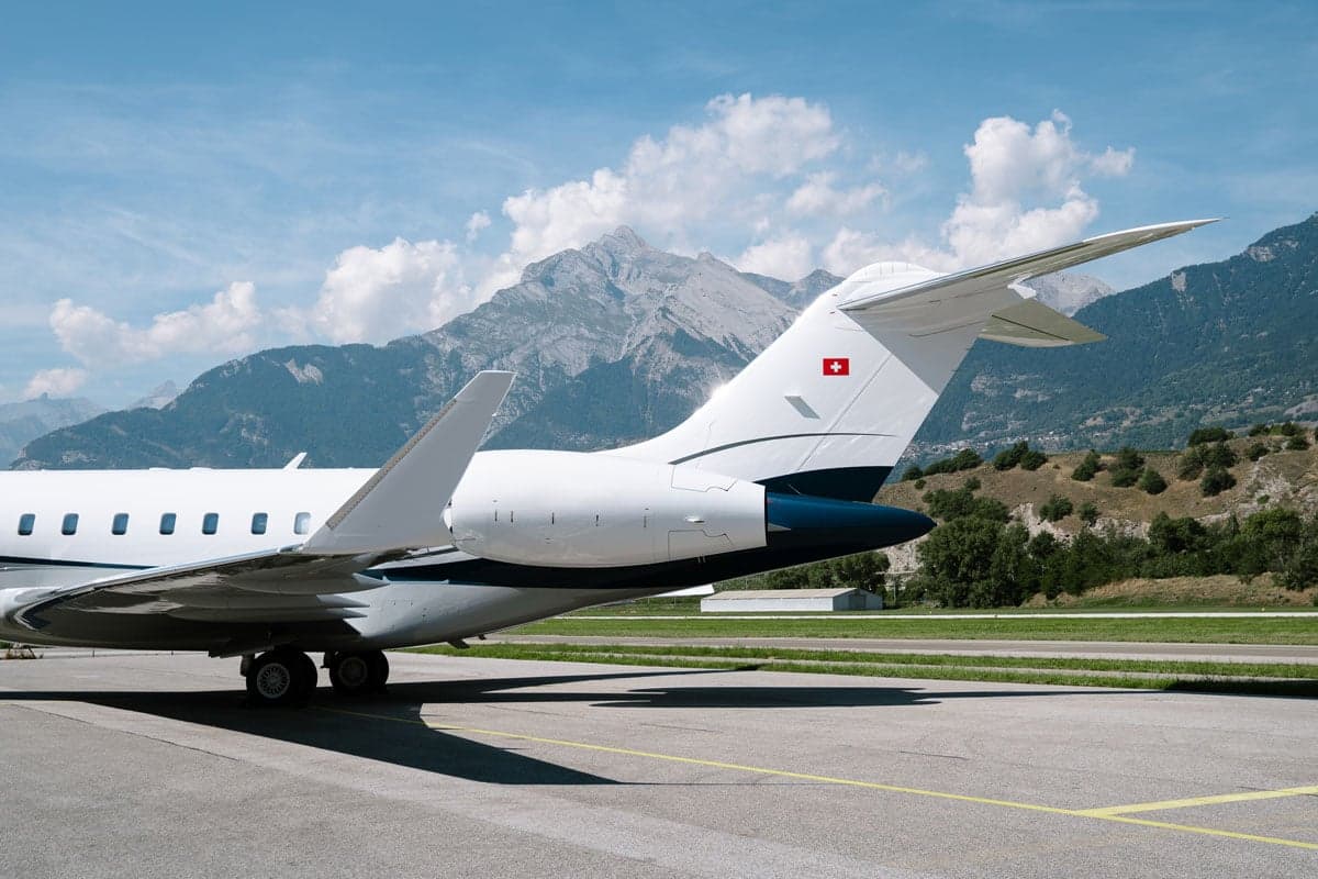 A view of the tail of a Bombardier Global XRS aircraft with a Swiss flag.