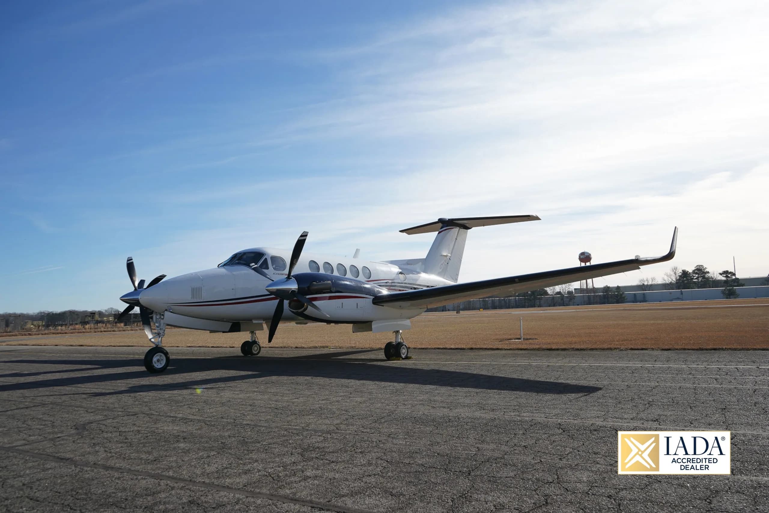 Beechcraft King Air 250 on the tarmac with a blue sky background.