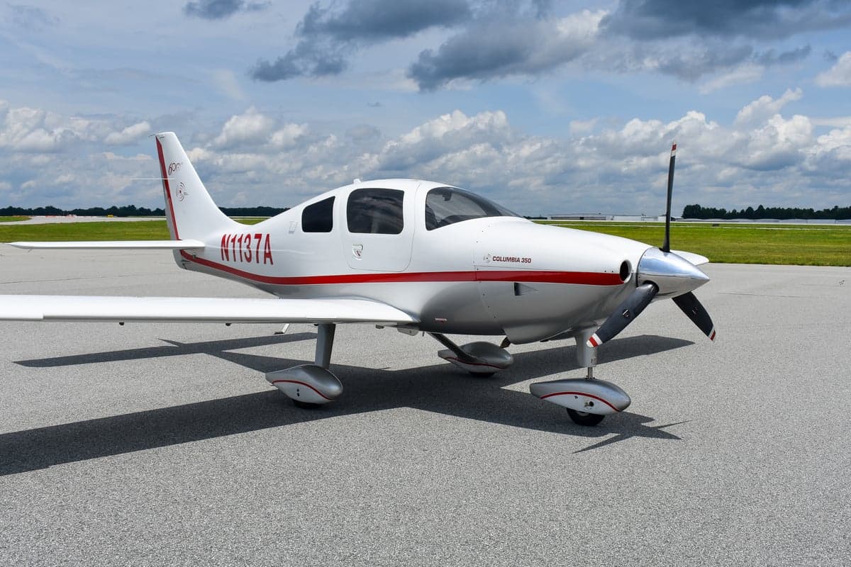 Columbia 350 aircraft N1137A with open doors on the tarmac.