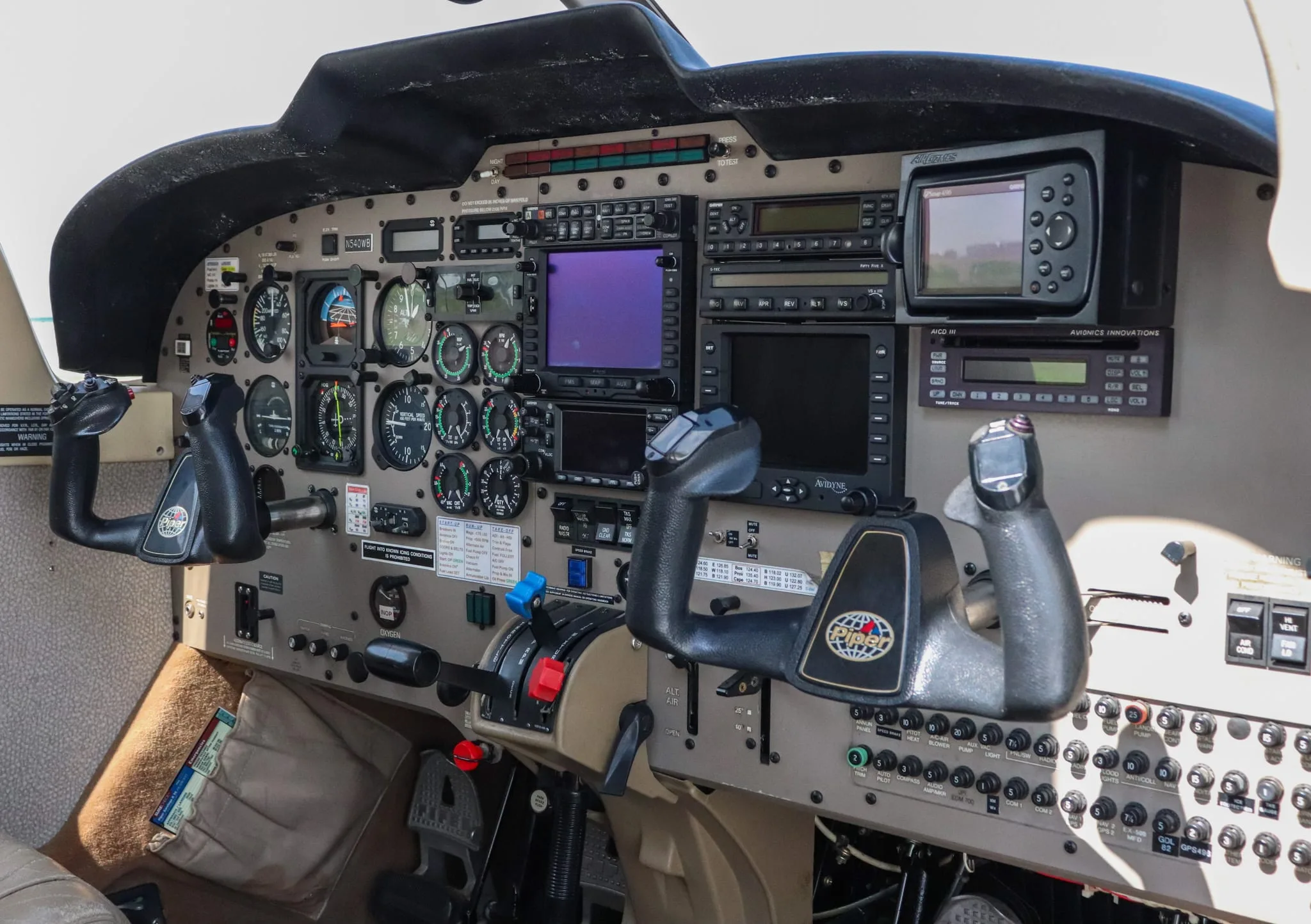 A slightly angled view of the Piper Saratoga II TC cockpit, highlighting the instrument panel and controls.