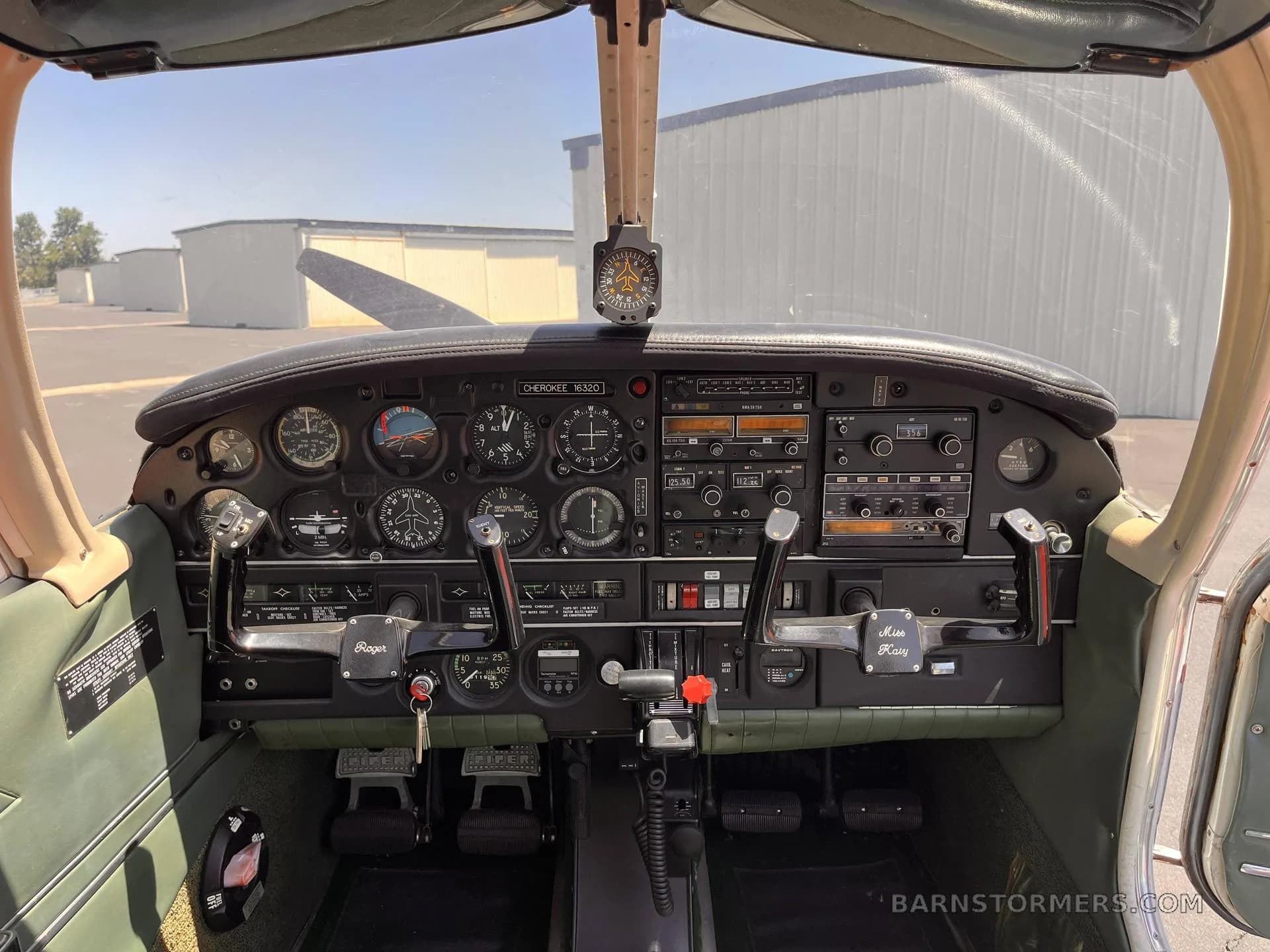 The cockpit of a Piper Cherokee N16320, showing the instrument panel, yoke, and controls.