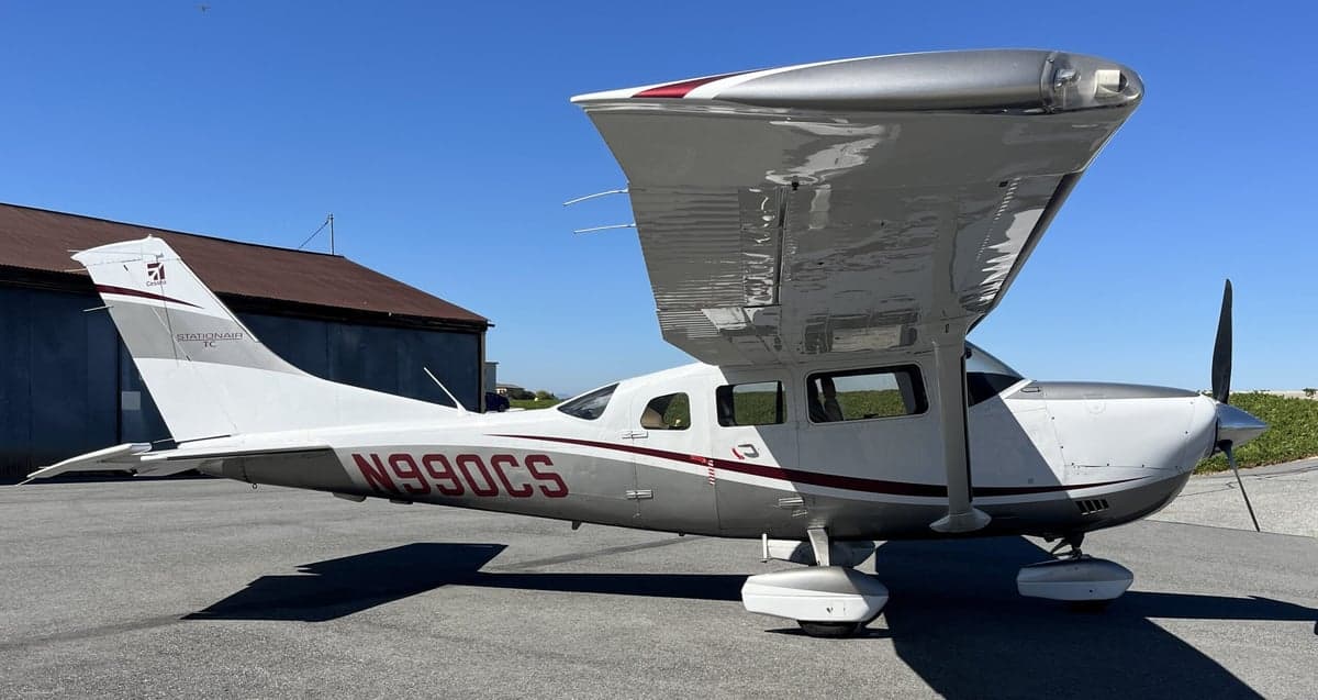 Side view of the Cessna T206H Stationair TC aircraft with registration N990CS.