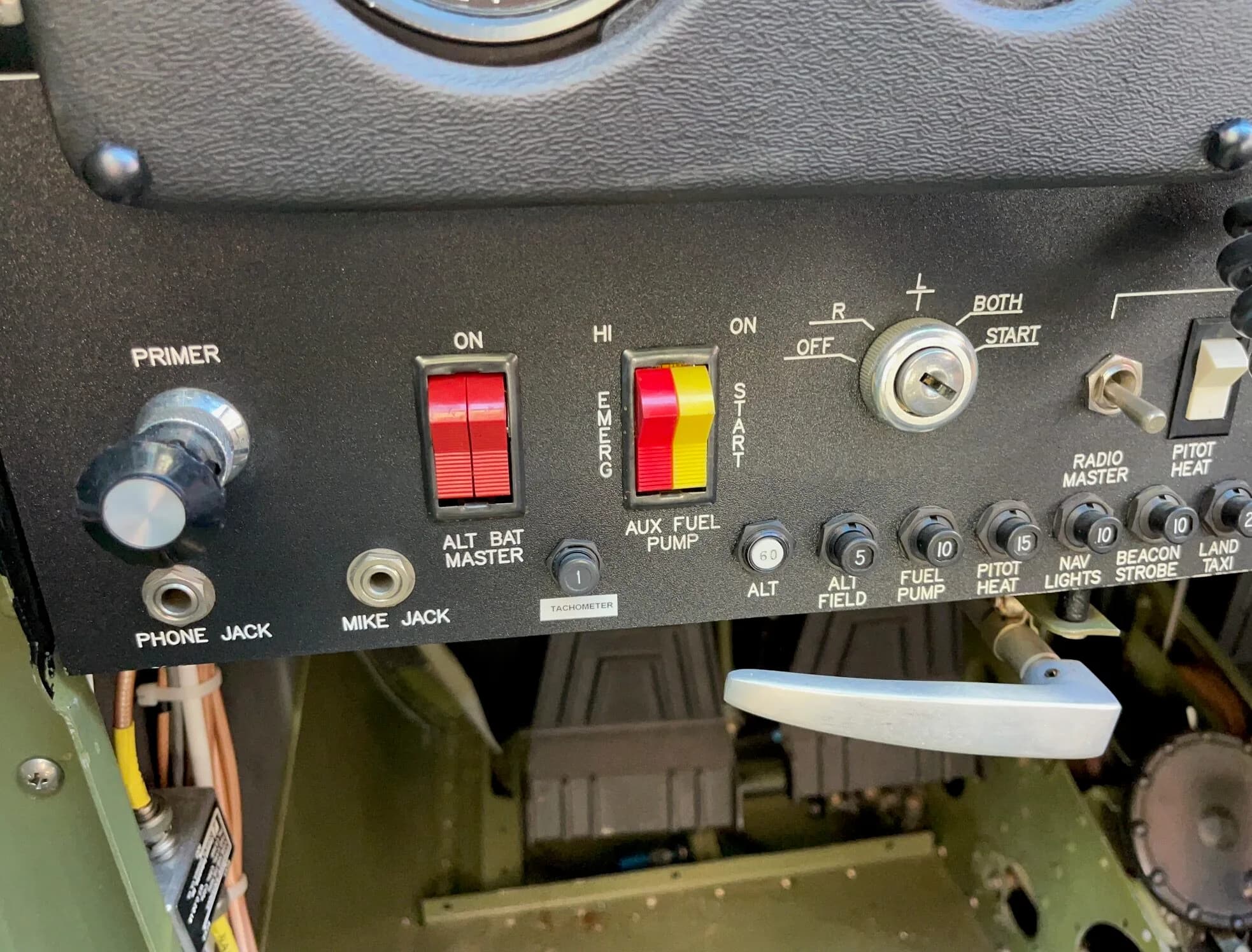 Close-up of the switches and controls on the instrument panel of an aircraft.