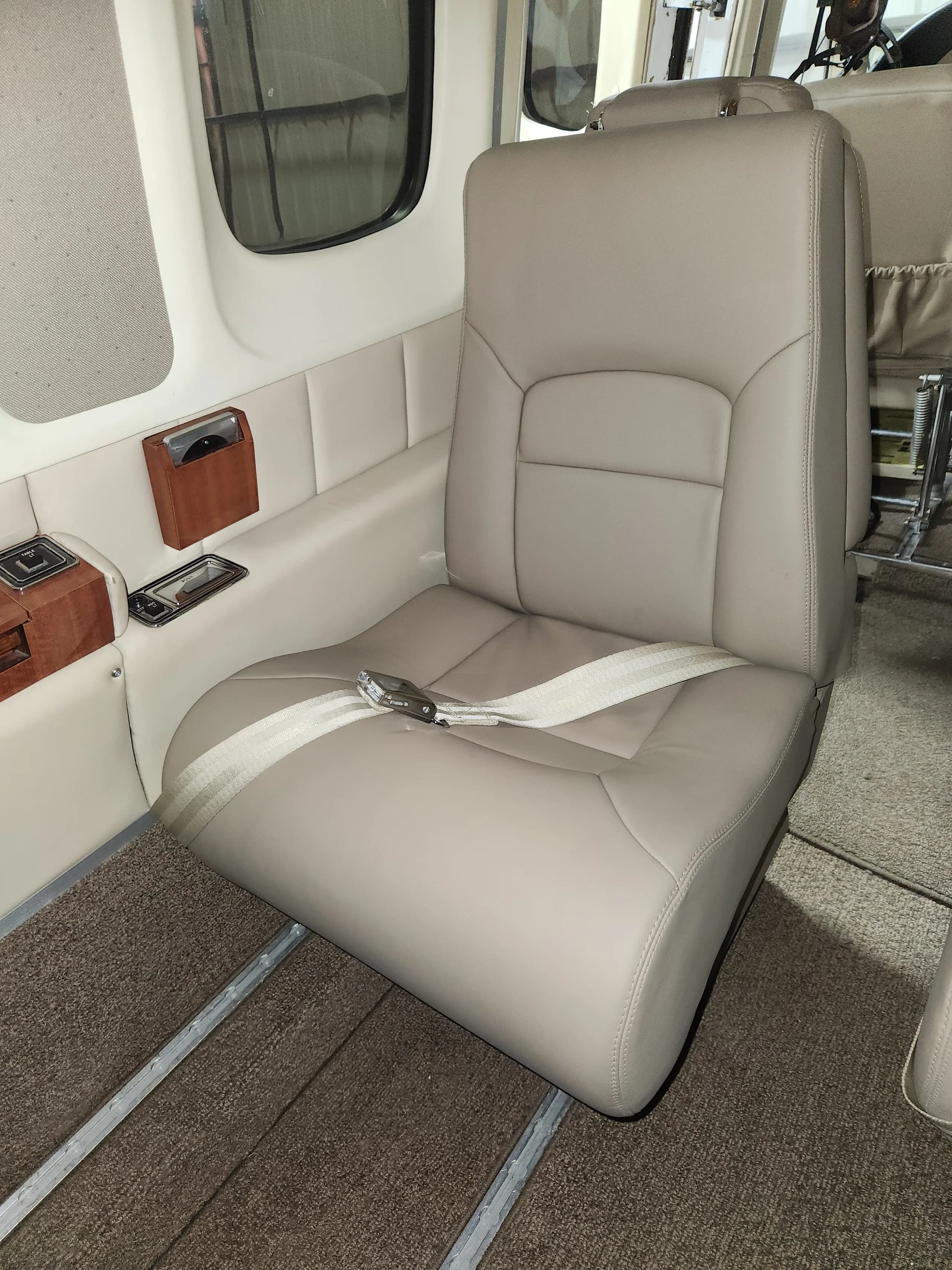 Close up of a tan leather seat in the Commando aircraft.