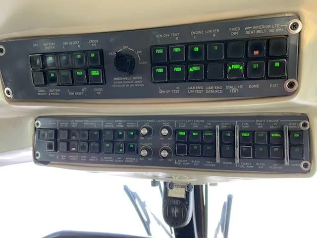 A close-up of the overhead panel in the cockpit, displaying various switches and indicator lights.